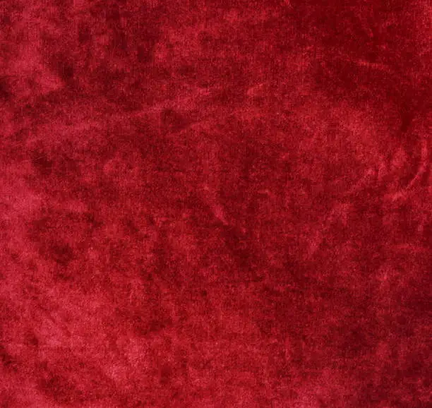 Photo of velvet texture background red color. Christmas festive baskground. expensive luxury, fabric, material, cloth.Copy space.