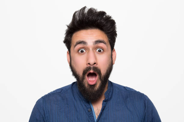 istock Portrait of shocked young man over white background 1069106142