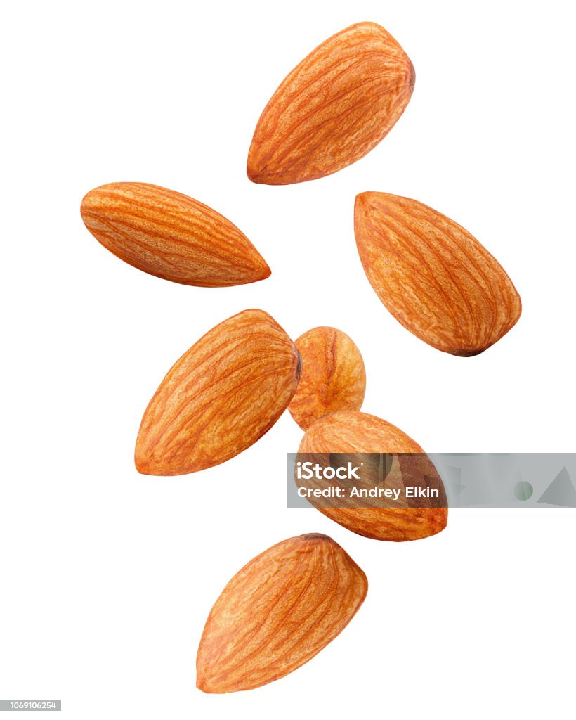 Falling almond isolated on white background, clipping path, full depth of field Almond Stock Photo