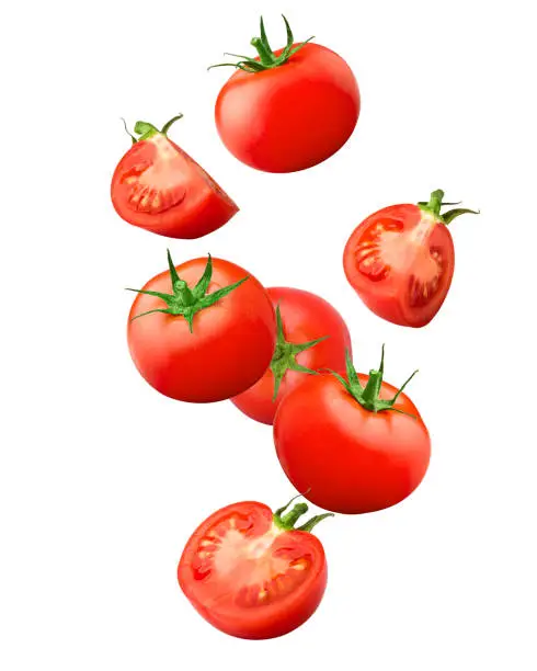 Photo of Falling tomato isolated on white background, clipping path, full depth of field