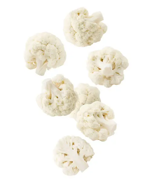 Photo of Falling cauliflower isolated on white background, clipping path, full depth of field
