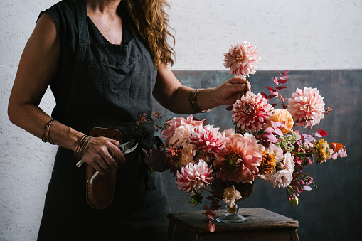 Florist making flower arrangements in her shop
