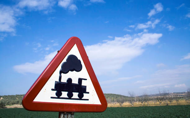 istock Warning sign worn of level crossing without barriers, blue sky with clouds 1069109710