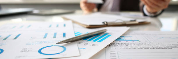 istock Silver pen lie at important paper on table in office 1069114400