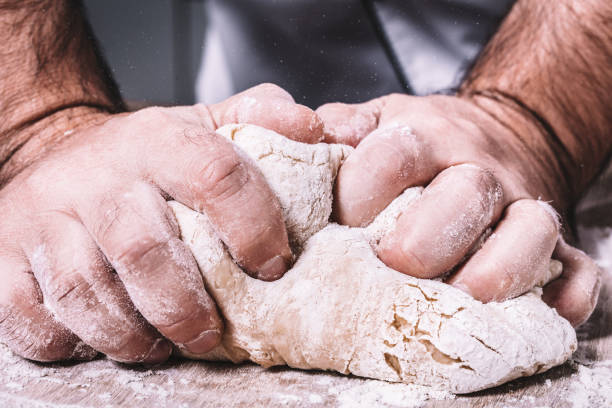 istock male chef kneads the dough 1069114444