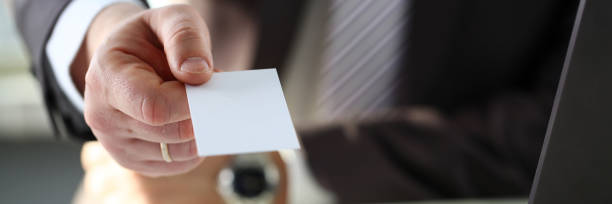 istock Male arm in suit give blank calling card 1069114452