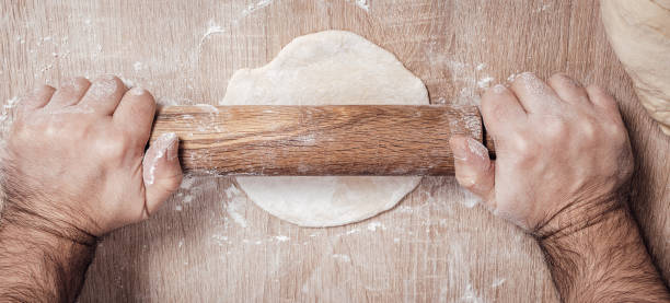 istock male chef kneads the dough 1069115718
