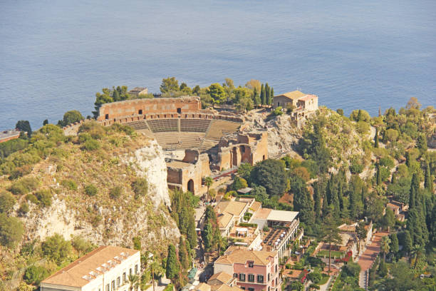 View of the Old Town of Taormina, the Sea and the Greek Theater. The island of Sicily, Italy View of the Old Town of Taormina, the Sea and the Greek Theater. The island of Sicily, Italy. greco stock pictures, royalty-free photos & images