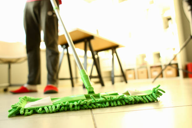 istock Green plastic mop cleaning laminated light dirty floor 1069118690