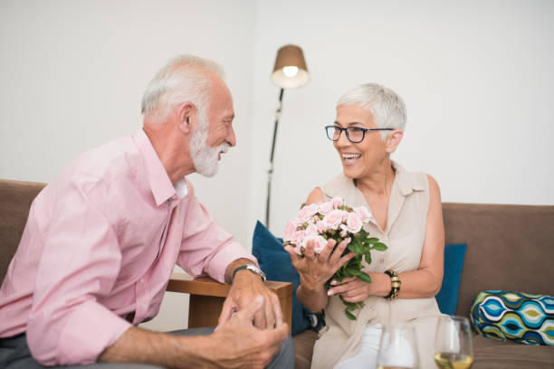istock Man giving his wife flowers 1069118706