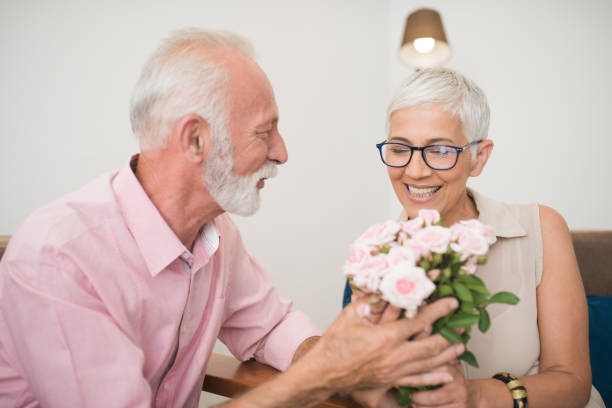 istock Man giving roses to his wife 1069118734