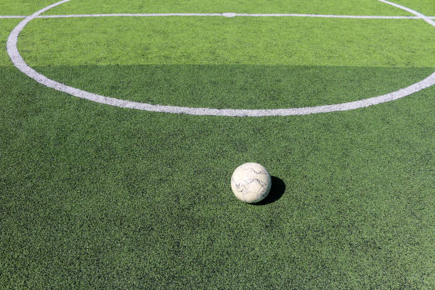 istock Football on artificial turf. It is for green background in a stadium 1069121824