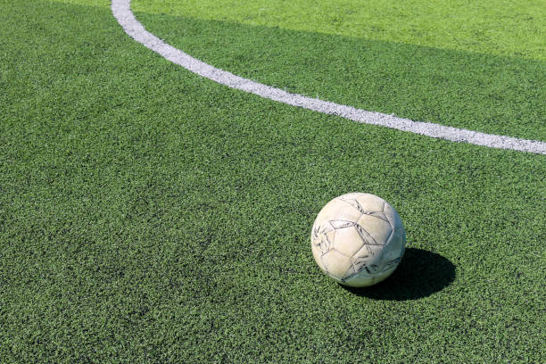 istock Football on artificial turf. It is for green background in a stadium 1069123914