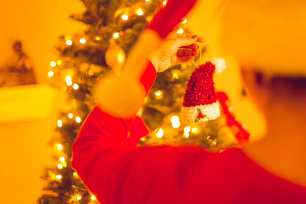 Christmas tree near the fireplace in the decorated living room