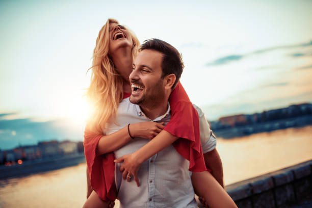 Couple in love Happy young couple having fun outdoors. heterosexual couple stock pictures, royalty-free photos & images