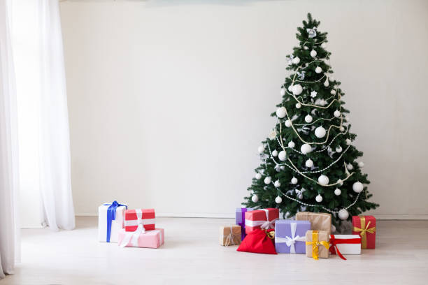 istock Green Christmas tree white decor gifts new year holidays 1069134190