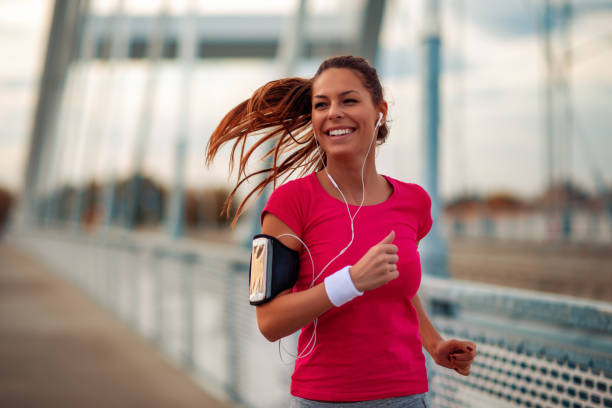 istock Young woman running outdoors in the city 1069134244