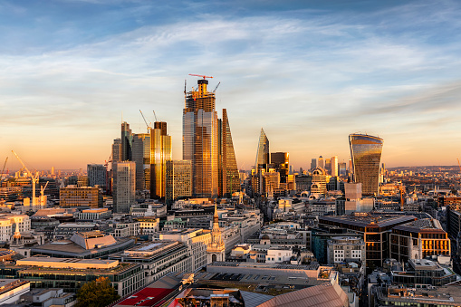 Sunset over the urban skyline of the financial district City of London, United Kingdom