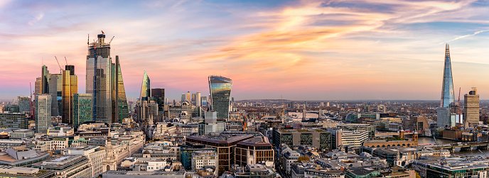 Panoramic view over the modern skyline of London: from the City to the Tower Bridge, just after sunset