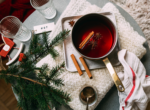 Non-alcoholic mulled wine with lemon and cinnamon in glass, flat lay