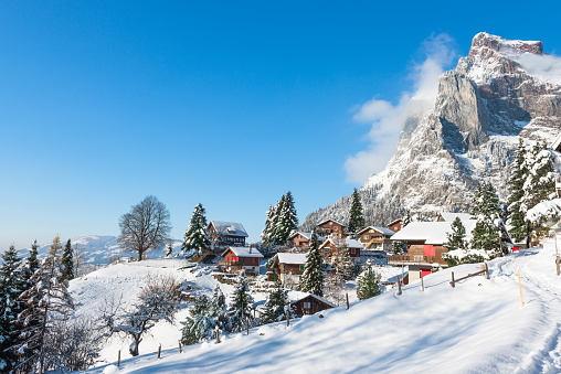 Village in the Alps in the snow. Winter Christmas holidays in Switzerland.