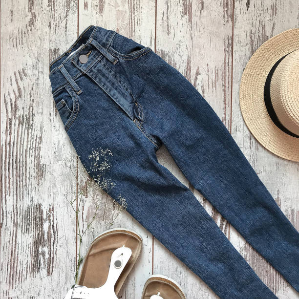 istock Blue jeans on a wooden background 1069136524