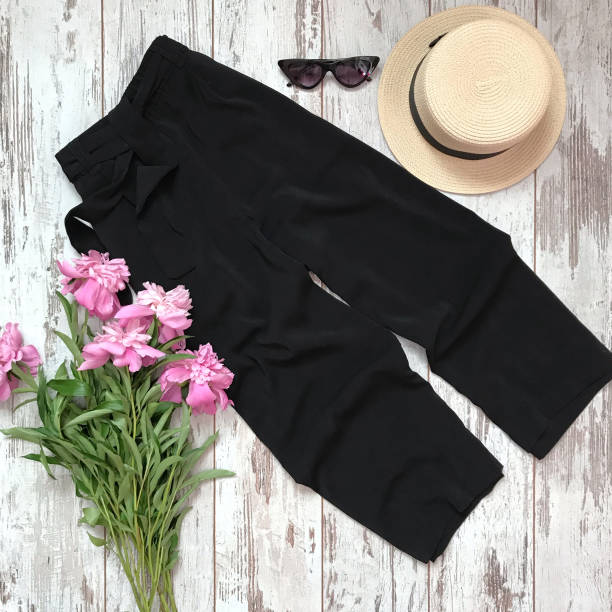 istock Black trousers on a wooden background 1069136896