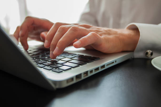 istock Business man using laptop computer. Male hand typing on laptop keyboard. 1069137362