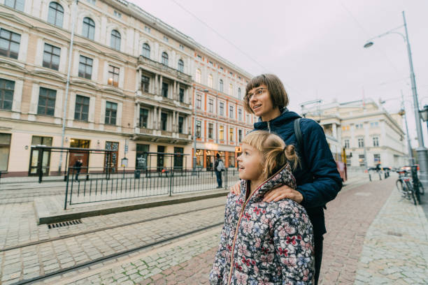 istock Mother with two daughter walking  in the city 1069139556