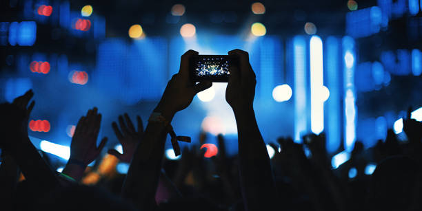 istock Unrecognizable fan filming concert with a smartphone. 1069141142