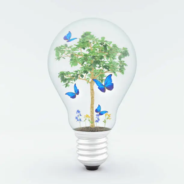 Photo of Green energy concept, tree inside light bulb 3d render