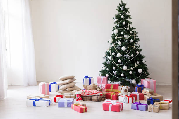 istock Green Christmas tree white decor gifts new year holidays 1069142260