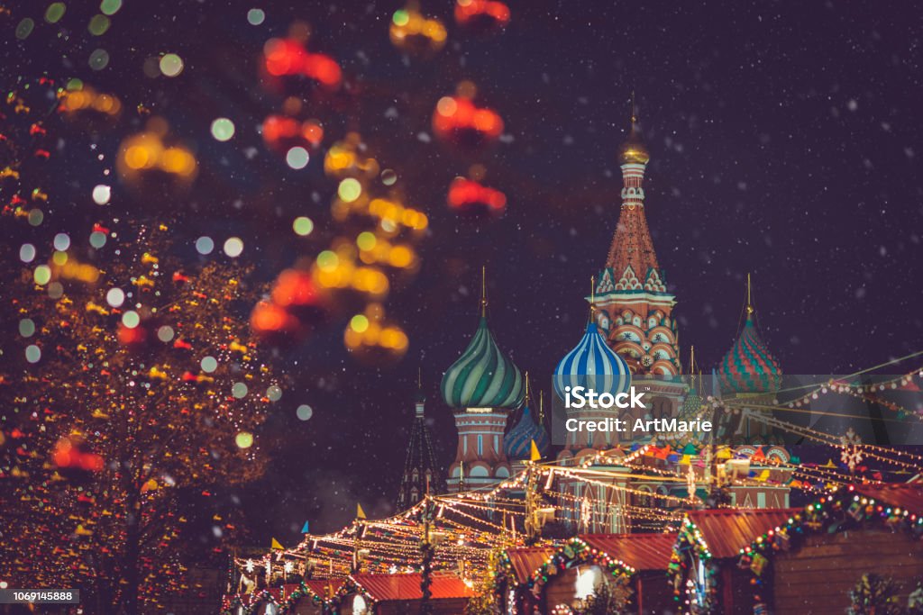 Christmas and New Year celebration market at the Red square in Moscow, Russia Christmas village in winter at the Red square near GUM, St. Basil's Cathedral and Kremlin in Moscow, Russia Moscow - Russia Stock Photo