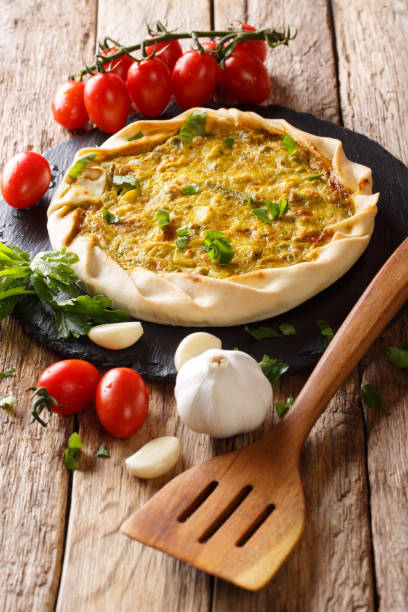 istock Homemade spicy potato pie with vegetables and herbs close-up on the table. vertical 1069150656