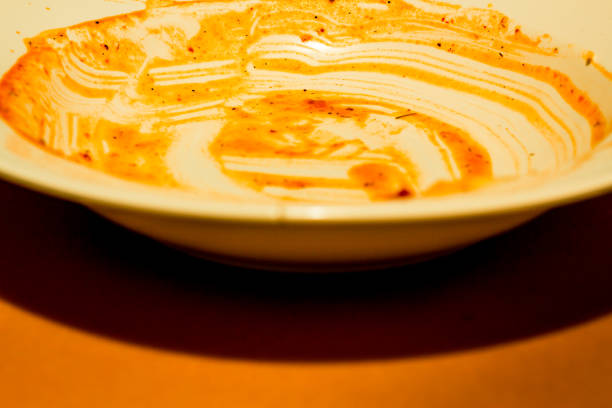 istock Dirty dish with tomato sauce ready to be cleaned 1069150892