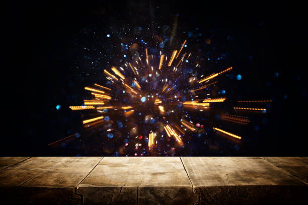 istock rustic wooden table in front of glitter lights burst. defocused. 1069156784