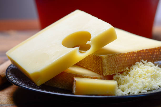 assortment of swiss cheeses emmental or emmentaler medium-hard cheese with round holes, gruyere, appenzeller and raclette used for traditional cheese fondue and gratin - cheese emmental cheese switzerland grated imagens e fotografias de stock