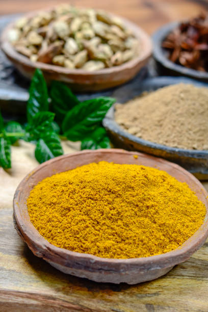 istock Old clay bowls wirh curry powder seeds close up, spices collection 1069158596