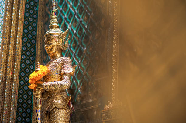 thai golden statue in standing position outside of wat pho, bangkok - art thailand thai culture temple imagens e fotografias de stock