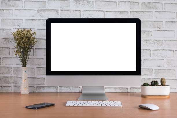 istock Blank screen of all in one computer with dry flowers, iPhone X and cactus vase on white bricks background 1069160822