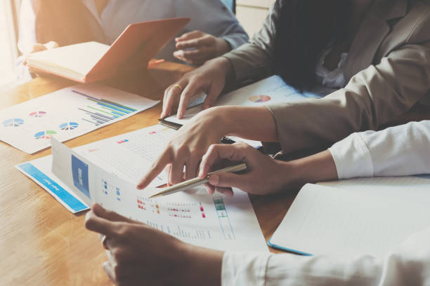 istock Business People Meeting using laptop computer,calculator,notebook,stock market chart paper for analysis Plans to improve quality next month. 1069166276
