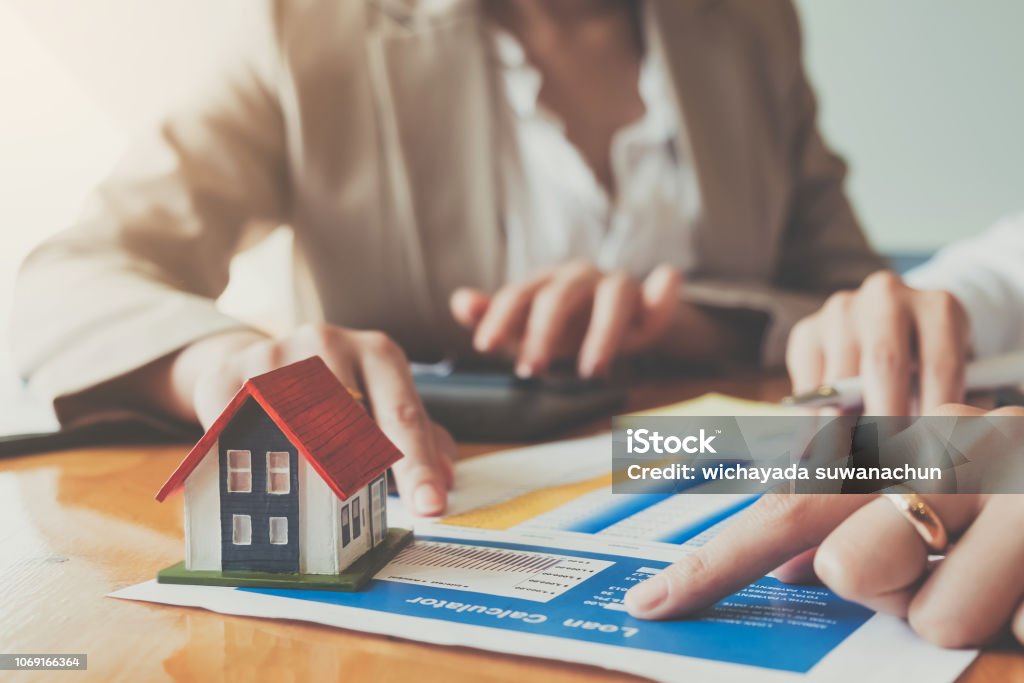 Close up hand of businesswoman signing contract Insurance protecting house. Financial Loan Stock Photo