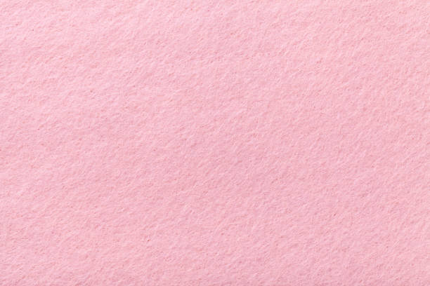 Light pink matt suede fabric closeup. Velvet texture of felt. Light pink matte background of suede fabric, closeup. Velvet texture of seamless rose woolen felt. felt textile stock pictures, royalty-free photos & images