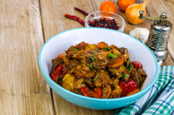 istock Uzbek cuisine. Fried vegetables with meat 1069175786