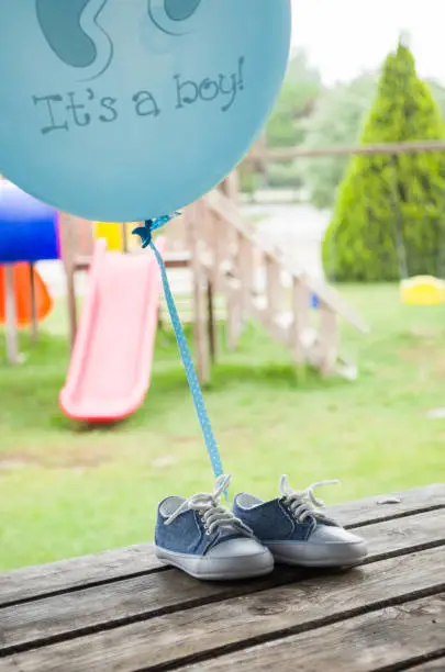Blue baby shoes on a wooden floor outdoors