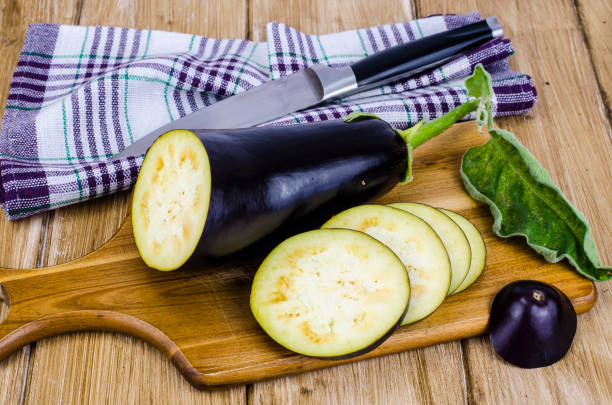 istock Ripe purple aubergine on wooden background 1069176406