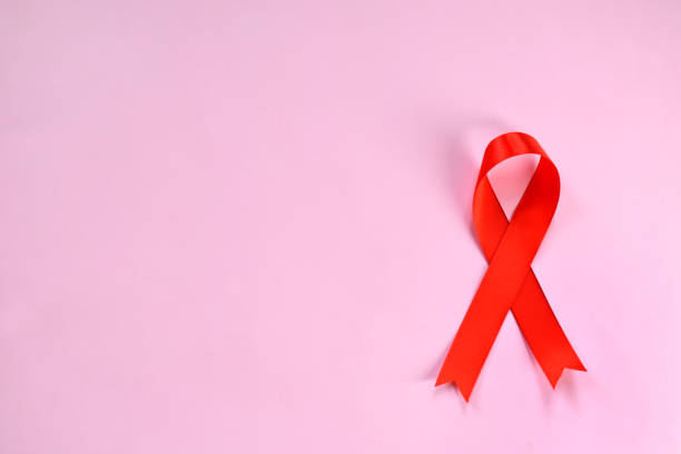 istock Red ribbon on pink background. World Aids Day concept 1069176416