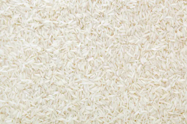 Uncooked white long-grain rice background