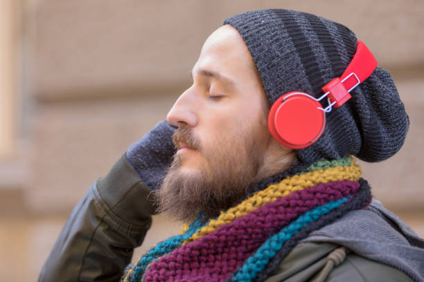 istock Young man with beard listening music 1069181970