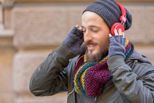 istock Young man with beard listening music 1069182826